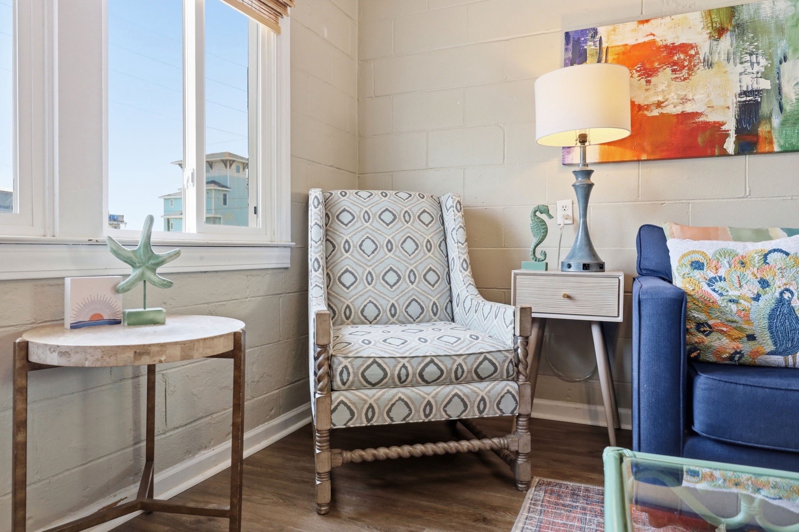 Unwind in your cozy reading nook with beachy décor, soft seating, and natural light inviting you to relax and recharge.