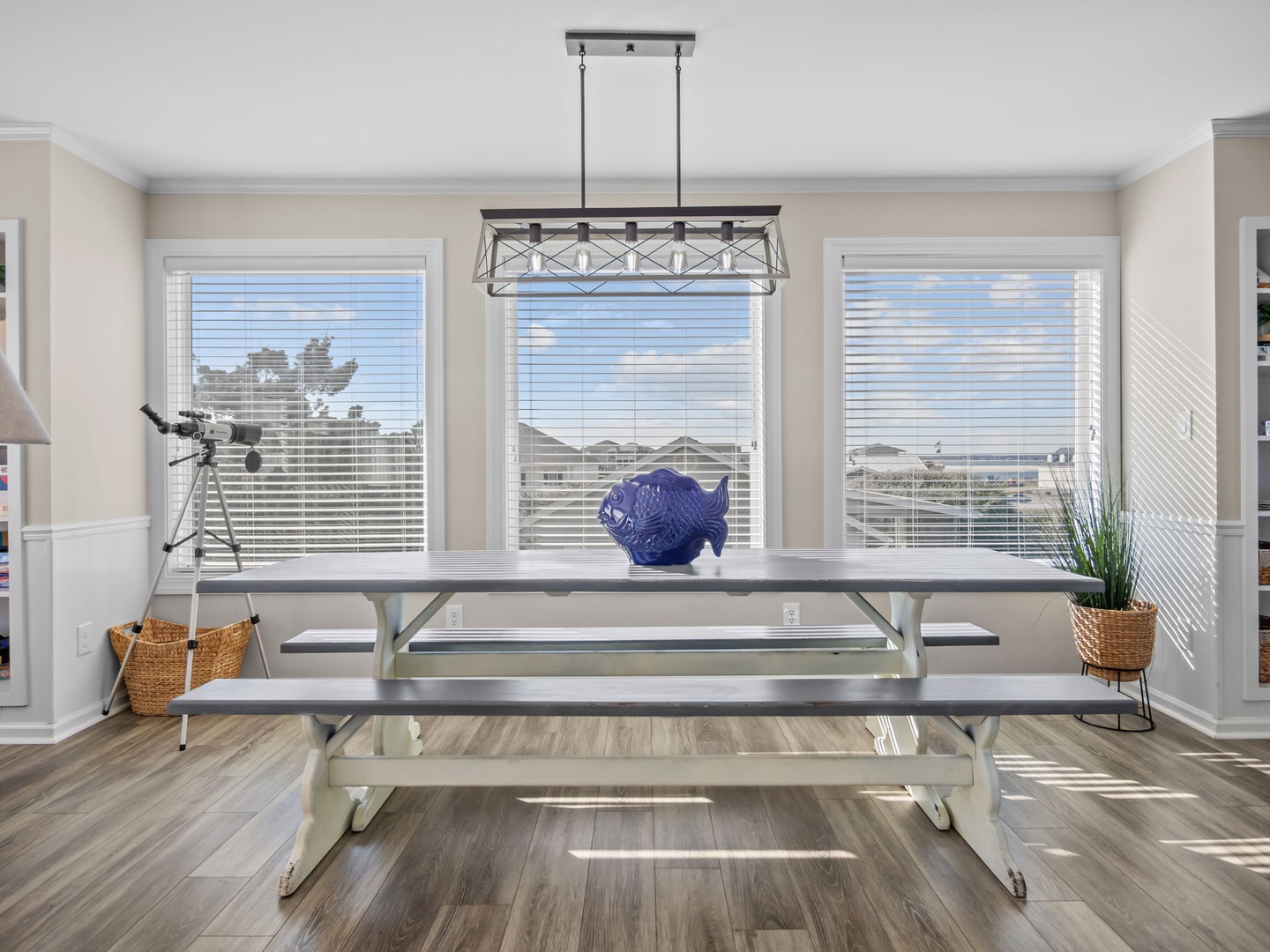 Gather around your spacious dining table with room for everyone, bathed in natural light from expansive windows.