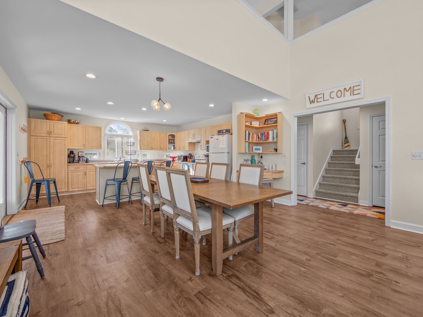 Gather around this spacious dining table where you'll share meals and create memories in your open-concept kitchen and dining area.