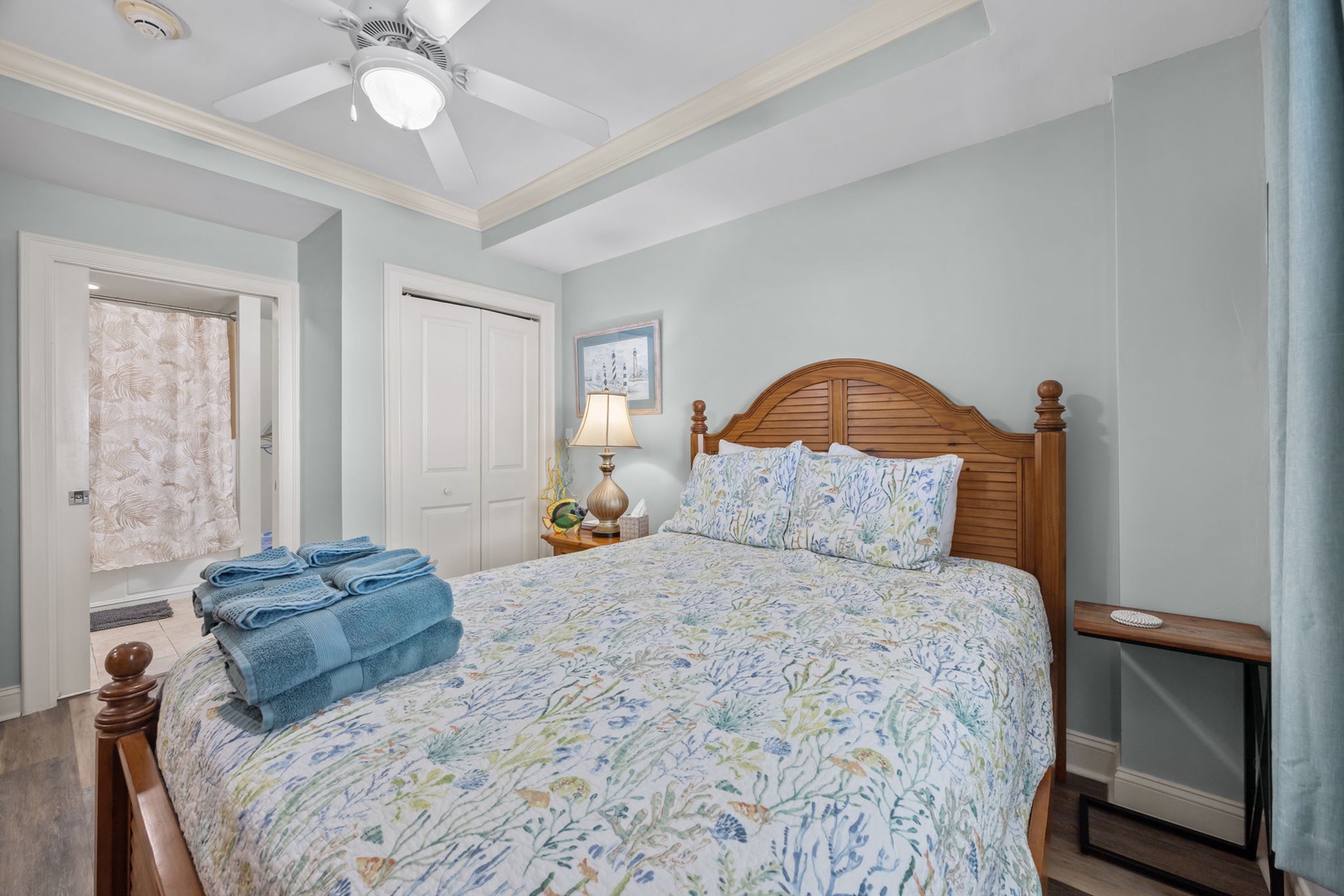 Unwind in your coastal-inspired bedroom with plush blue linens and coastal charm for peaceful nights.
