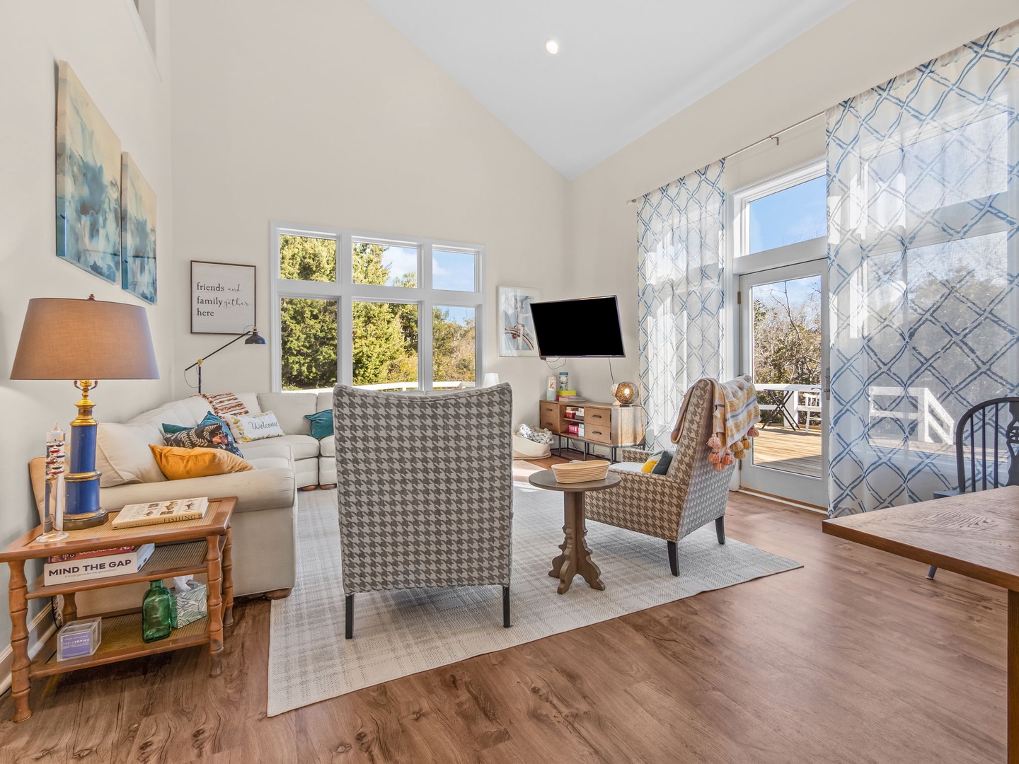 Unwind in your bright, airy living space with plush seating, natural light streaming through large windows, and charming touches throughout.