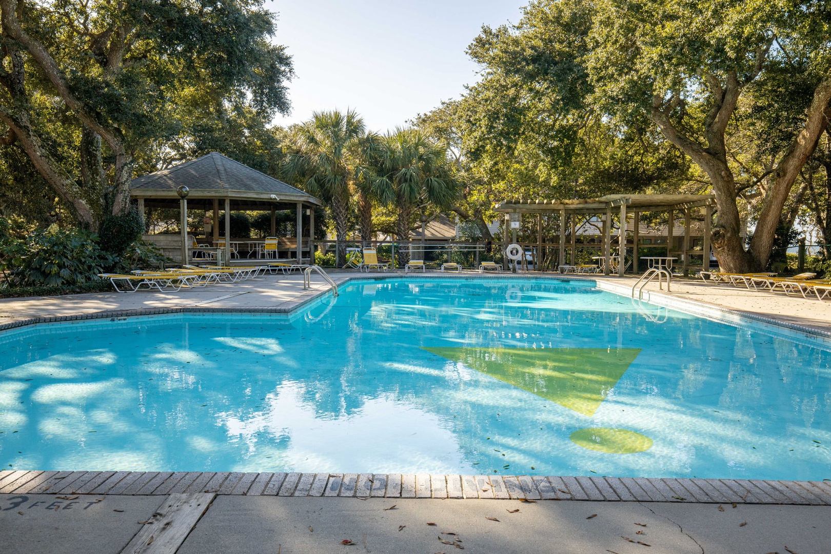 Sparkling pool surrounded by lush trees and gazebos creates your perfect tropical retreat for relaxation and fun.