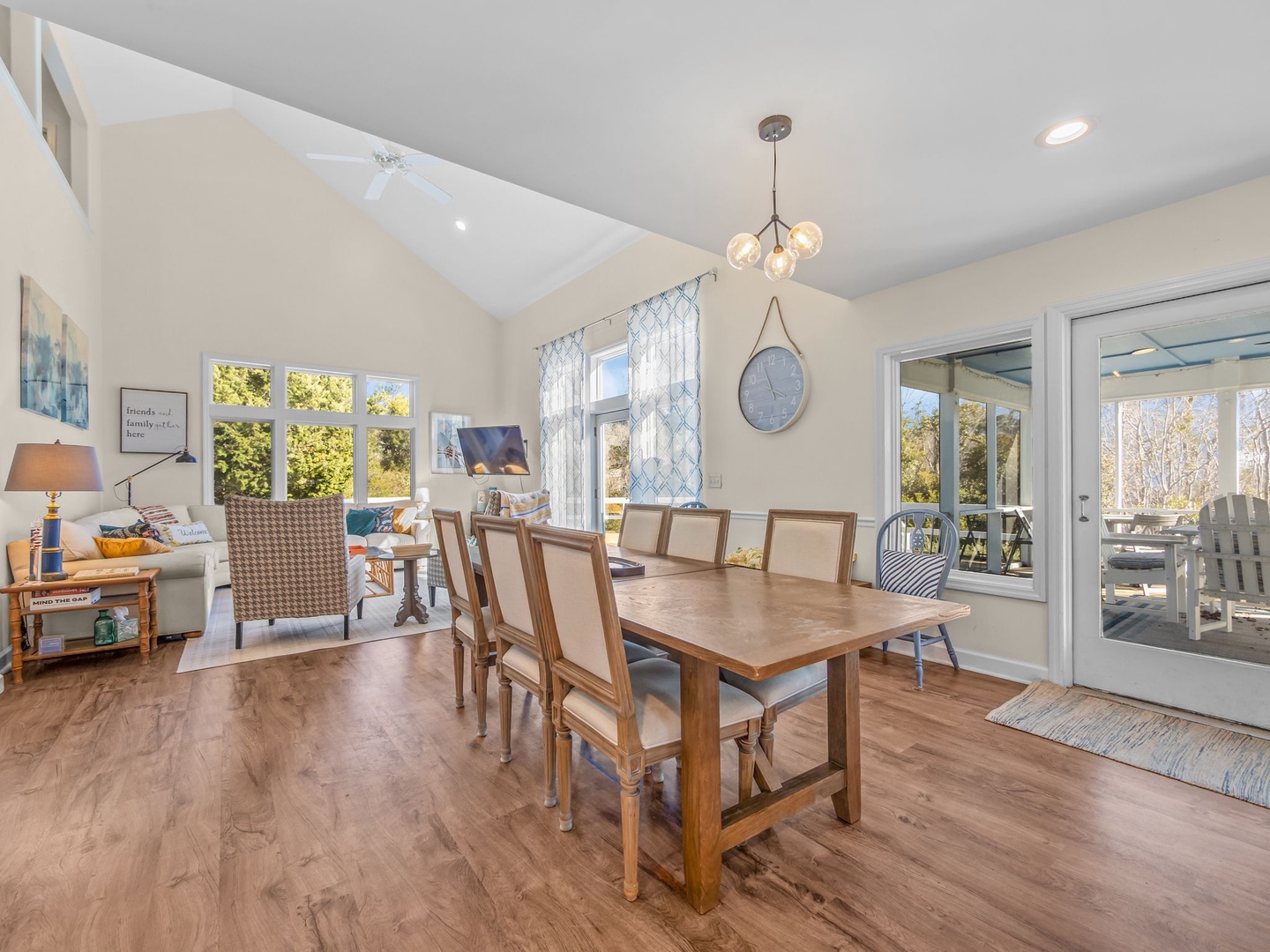 Gather around the warm wooden table where meals become memories, with natural light streaming through windows and seamless patio access.