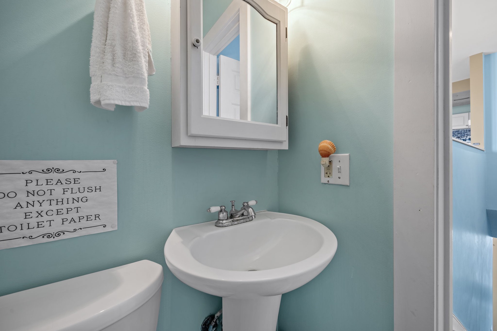 Refresh in your charming coastal-themed bathroom with soft aqua walls, fluffy towels, and thoughtful touches that make you feel at home.