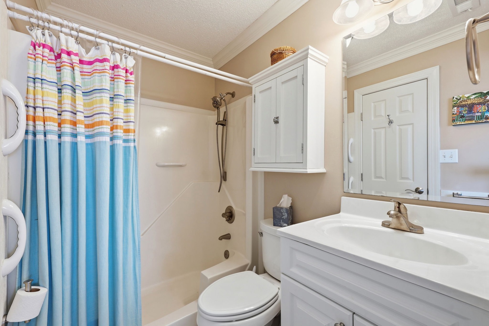 Freshen up in your private bathroom with a full tub-shower combo, crisp white cabinetry, and plenty of storage for your essentials—perfect for unwinding after a day of adventure.