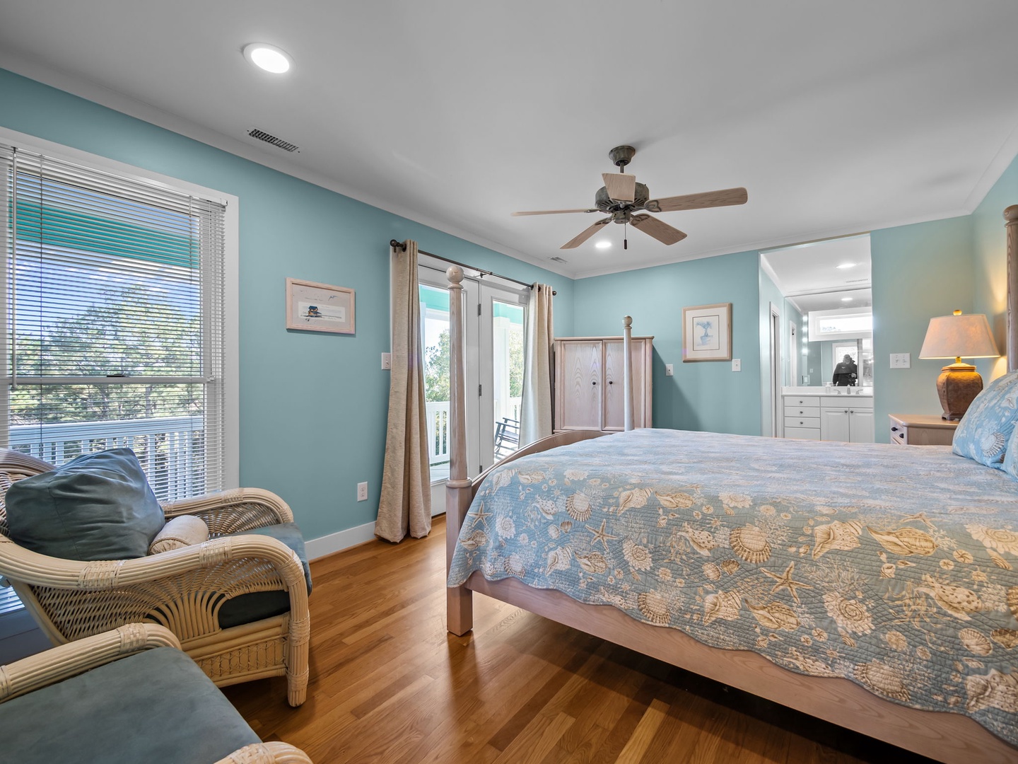 Unwind in your tranquil bedroom sanctuary with soothing ocean colors, warm hardwood floors, and French doors opening to your private balcony.