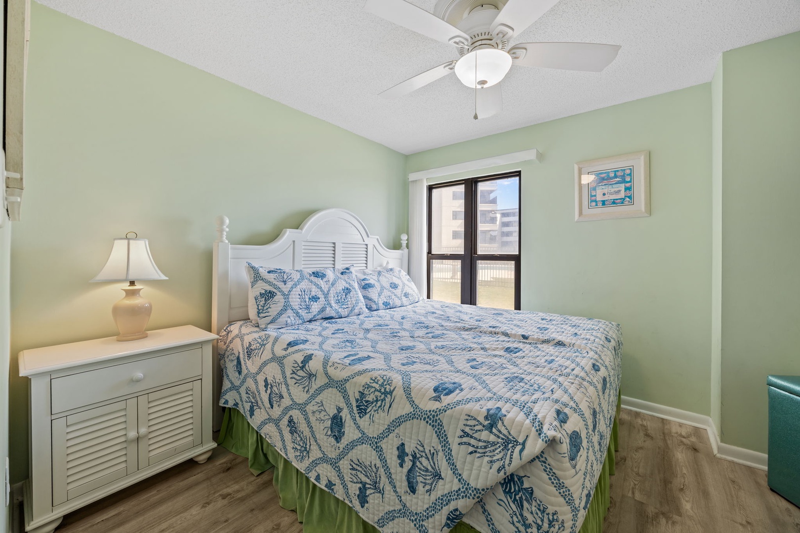 Drift into peaceful dreams surrounded by soothing mint walls and ocean-inspired bedding that perfectly captures the coastal spirit.