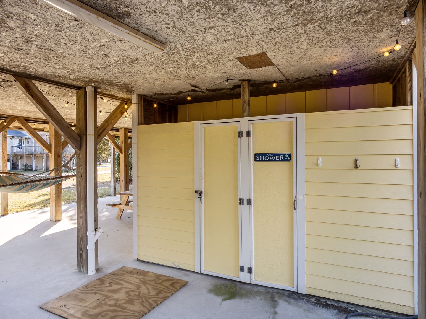 Rinse off salt and sand in your private outdoor shower after beach days, complete with warm lighting and coastal charm.