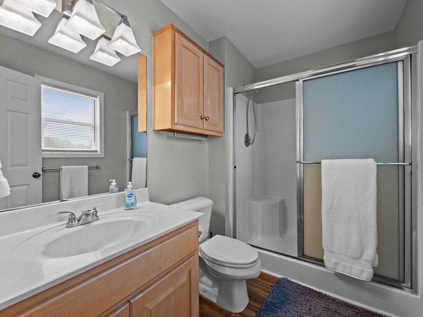 1st Floor : Your bright bathroom features warm wood cabinetry, fresh towels, and a convenient walk-in shower - perfect for refreshing after your adventures.