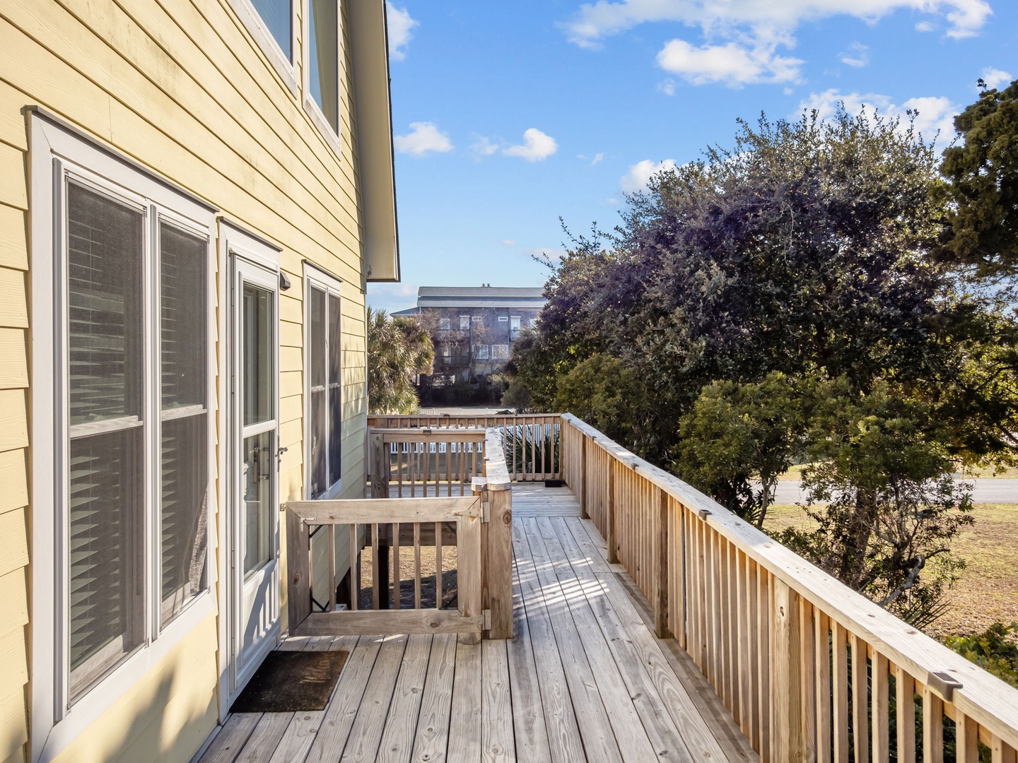 Step onto your private deck and breathe in the fresh air while enjoying peaceful neighborhood views surrounded by mature trees.