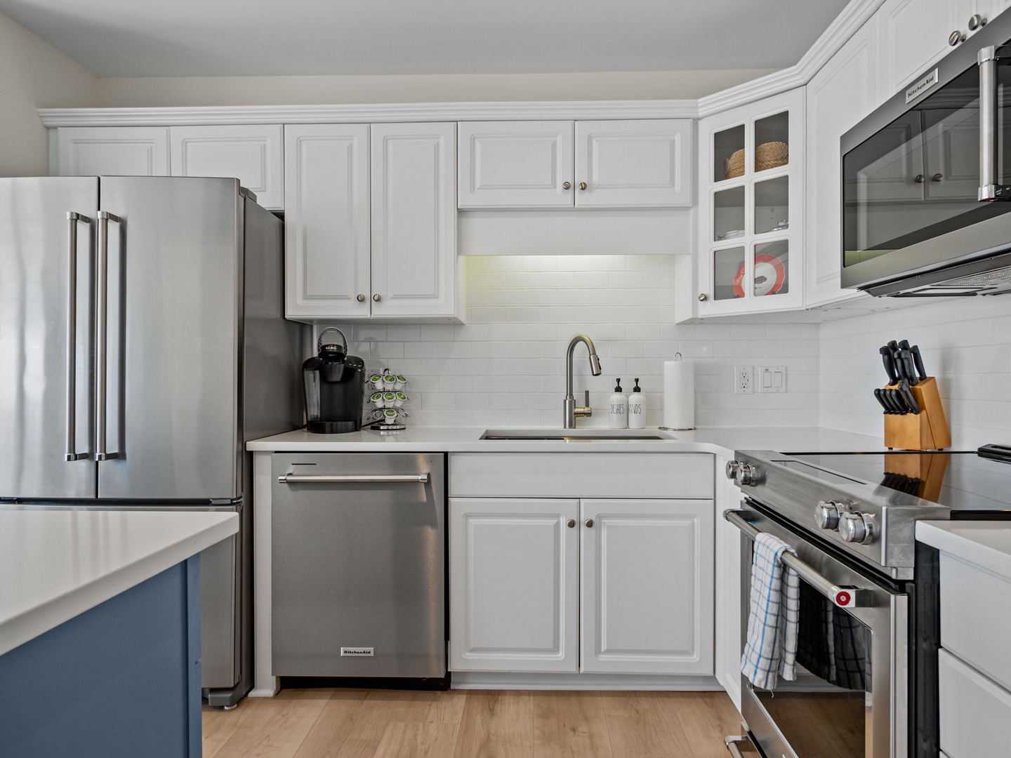 Step into your fully equipped kitchen with stainless steel appliances and crisp white cabinetry, ready for your culinary adventures.