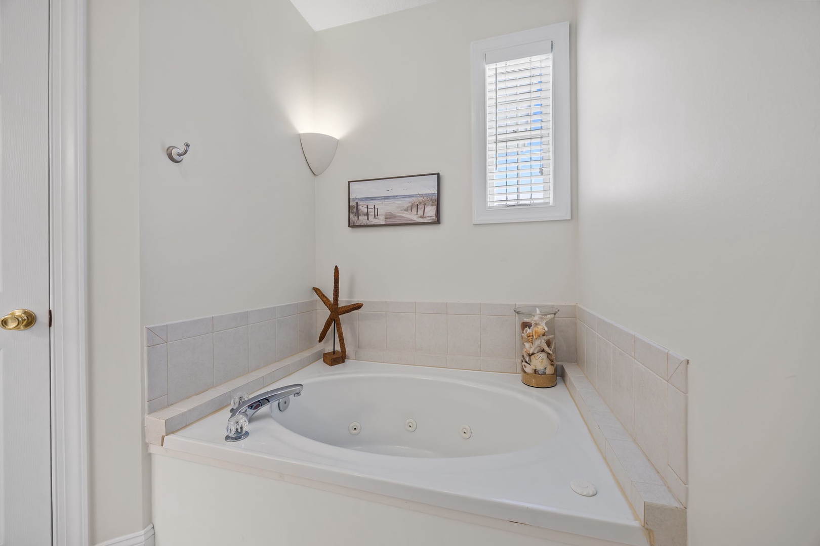 Sink into pure relaxation in your private jetted tub, where coastal decor and soft lighting create the perfect retreat.