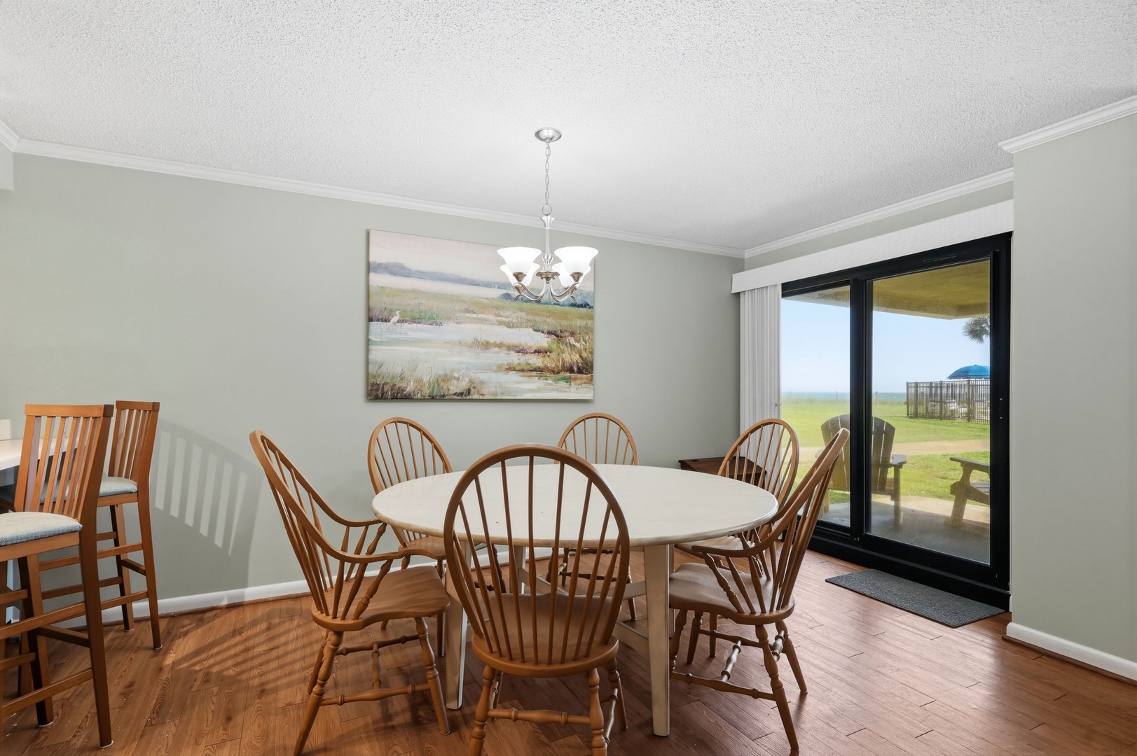 Gather around the table for meals with loved ones, bathed in natural light from the sliding doors that open to your private outdoor space and scenic views beyond.