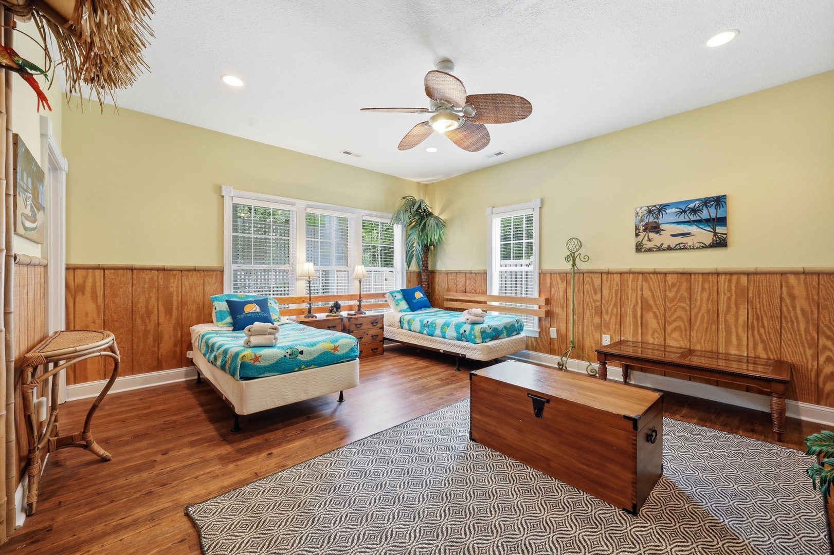Your coastal retreat awaits with cheerful twin beds, warm wood tones, and tropical touches—perfect for sharing sunny vacation memories with your favorite travel companion.