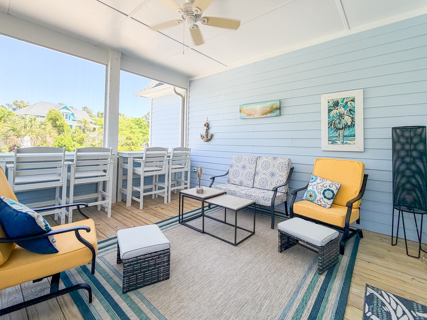Unwind on your private screened porch with coastal charm—plush seating, a ceiling fan, and a dining table for morning coffee or evening relaxation with a breeze.