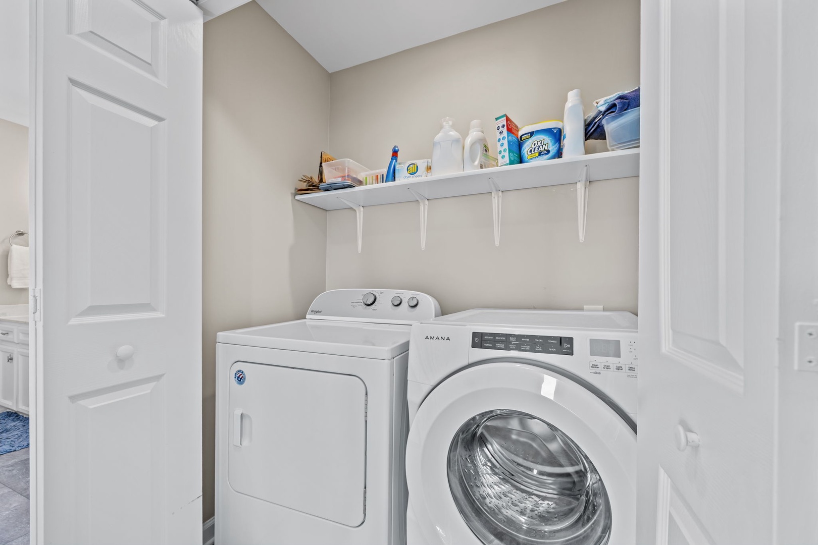 Your dedicated laundry room keeps everything organized with full-size washer and dryer plus convenient shelving for supplies.