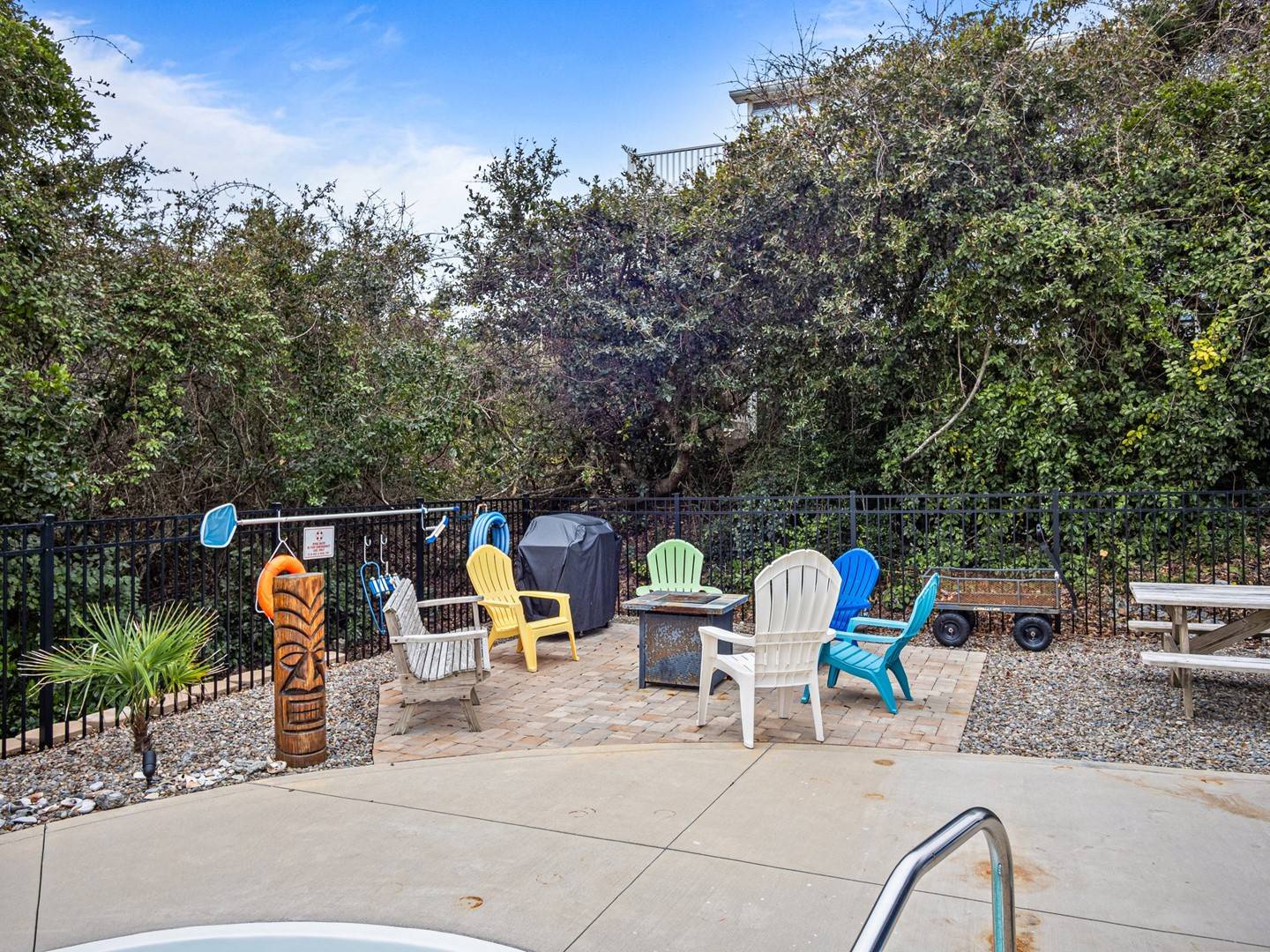 Gather around your private fire pit under blue skies, with colorful Adirondack chairs perfect for evening conversations and s'mores.