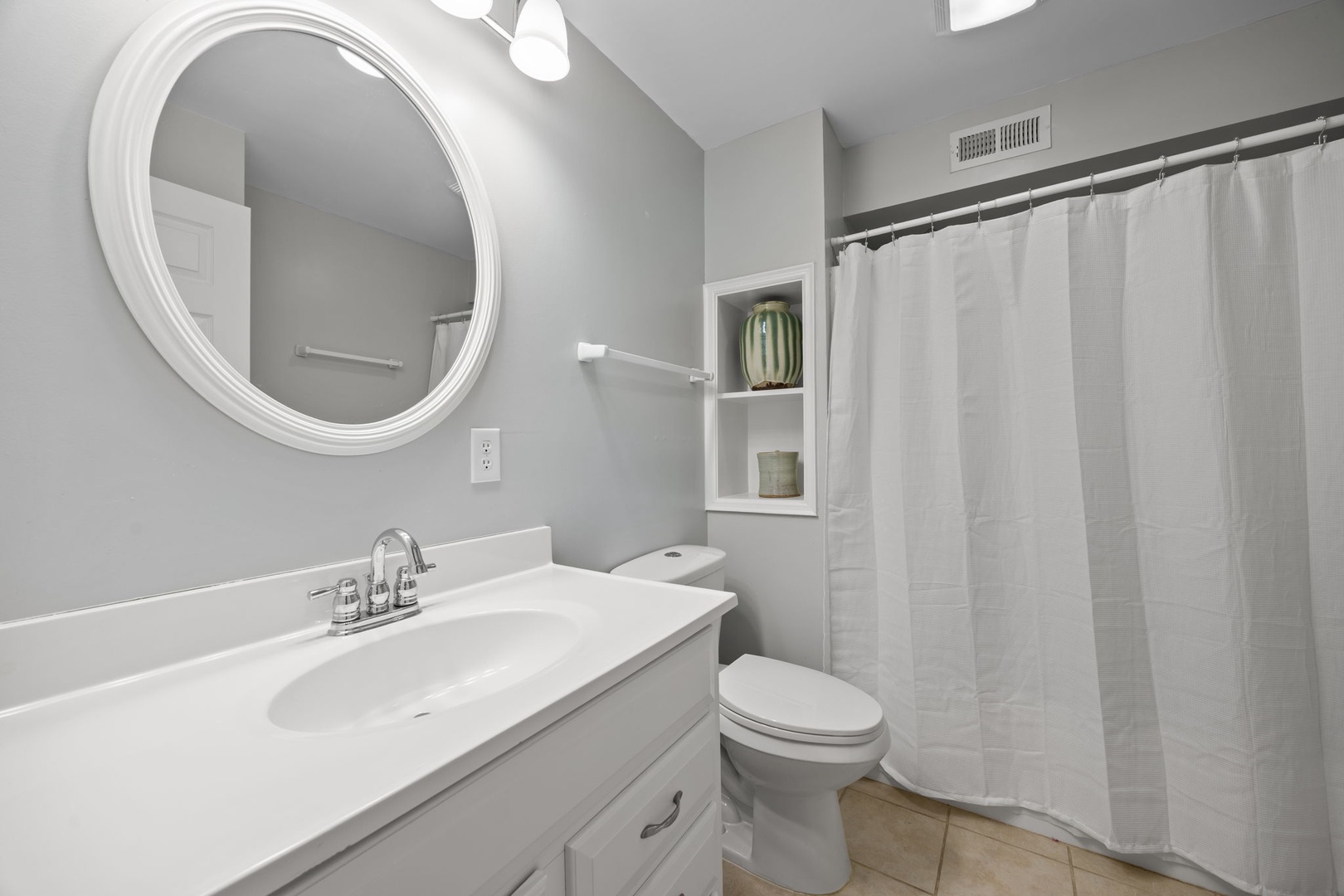 Step into your pristine bathroom featuring fresh linens, elegant fixtures, and thoughtful built-in storage for all your essentials.