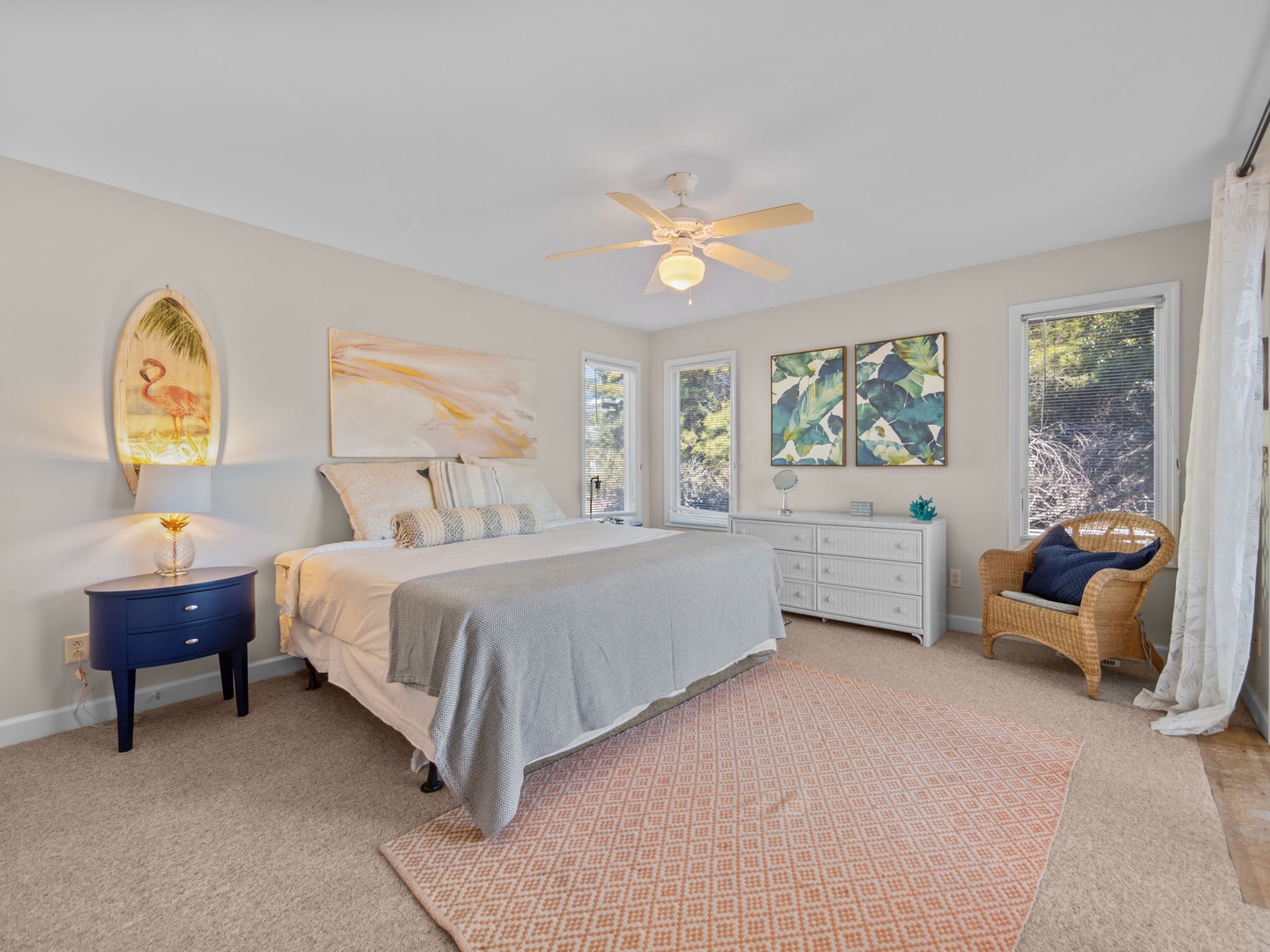 Drift into peaceful sleep in your stylish master suite, where coastal art and a gentle ceiling fan create your perfect retreat.