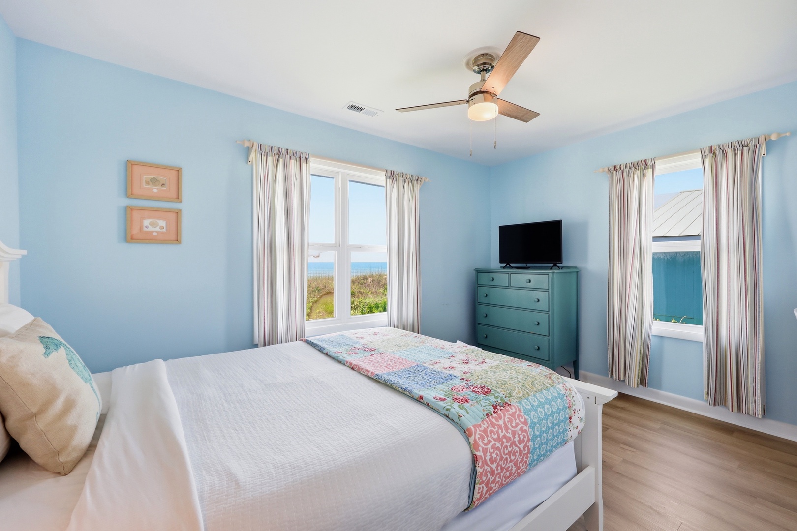 Wake up to peaceful ocean views framed by soft curtains in your serene coastal bedroom, where beach breezes and the sound of waves start your perfect day.