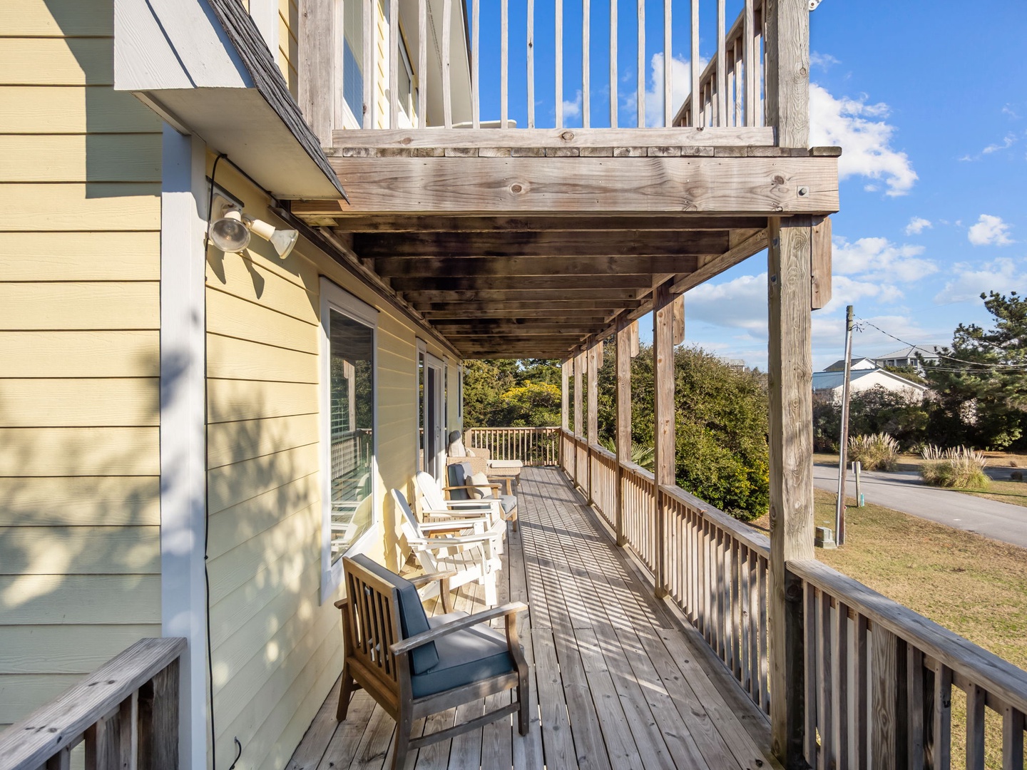 Relax on your private covered deck with comfortable seating while enjoying peaceful neighborhood views.