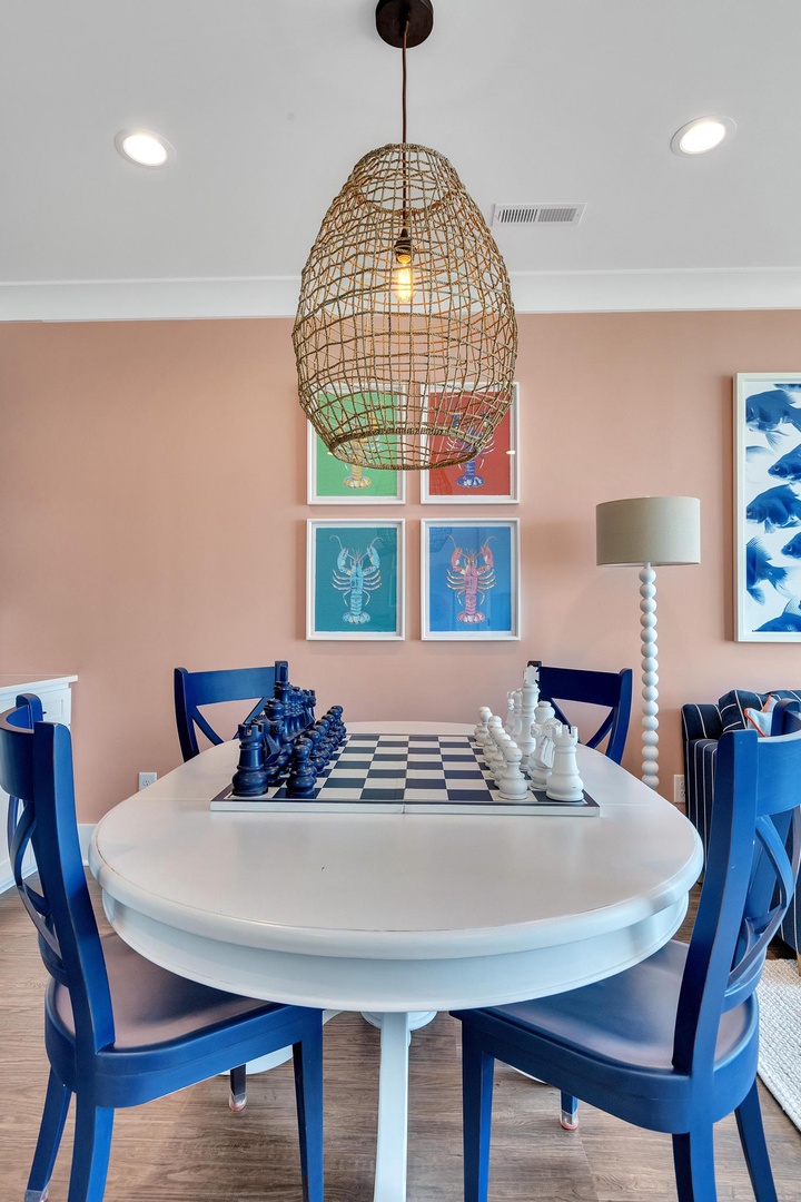 Gather around the dining table for game night or meals with loved ones. The coastal-inspired décor and natural light create a warm, inviting space where memories are made.