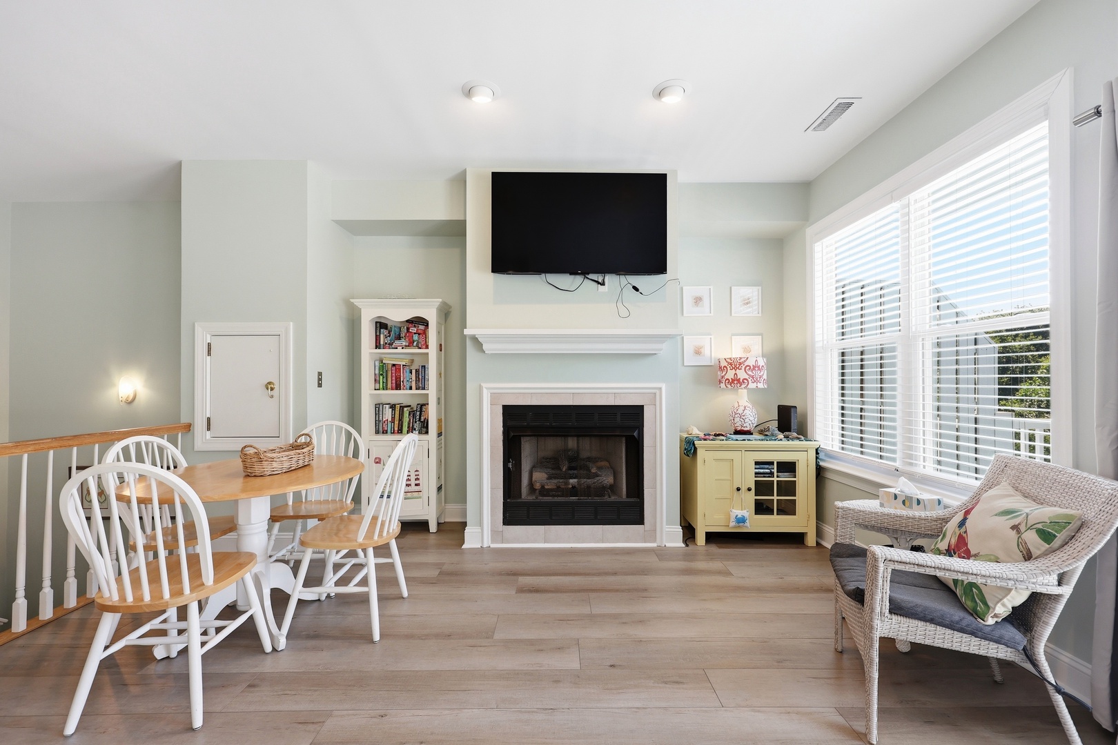 Step into your cozy retreat where a warm fireplace and coastal charm invite you to unwind. Sunlight filters through bright windows as you enjoy meals at your dining table or relax with your favorite show.