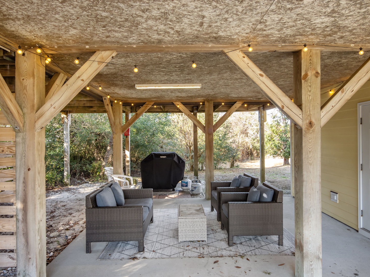 Relax under your private pavilion with comfortable seating and warm string lights creating the perfect ambiance for evening conversations.