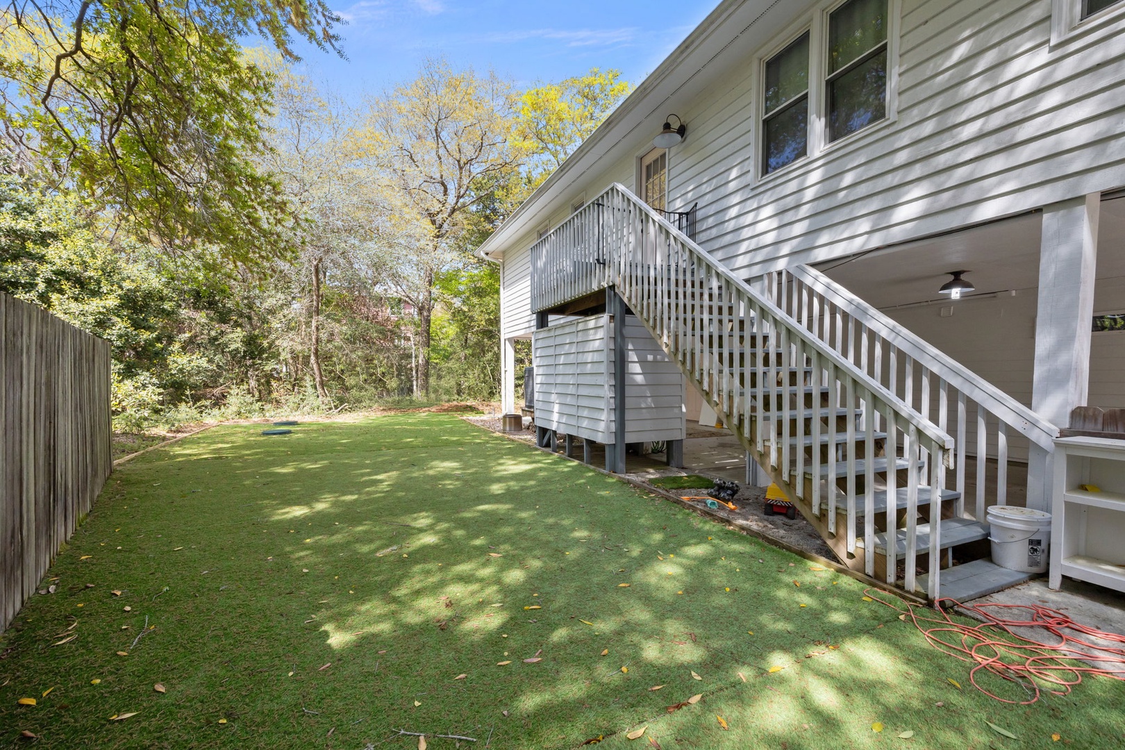 Relax in your private backyard oasis with lush green lawn, shaded by mature trees—perfect for morning coffee or evening gatherings.