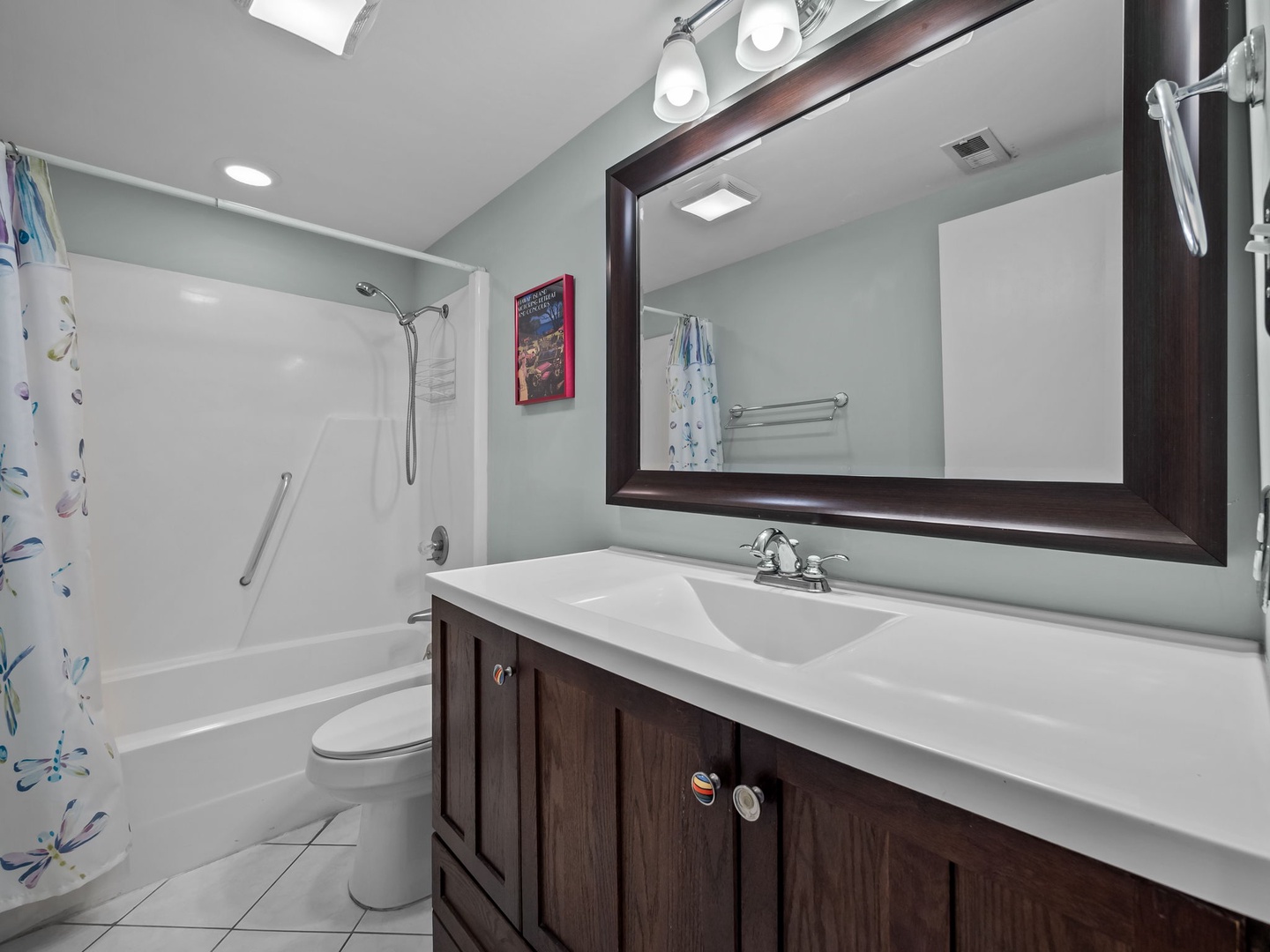Refresh in your spacious bathroom with modern fixtures, elegant vanity, and convenient tub-shower combo—perfect for unwinding after busy vacation days.