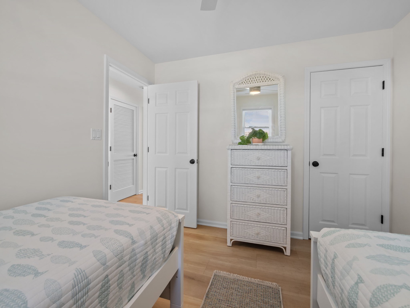 Your peaceful twin bedroom features soft coastal linens and ample storage, creating a serene retreat for restful nights.