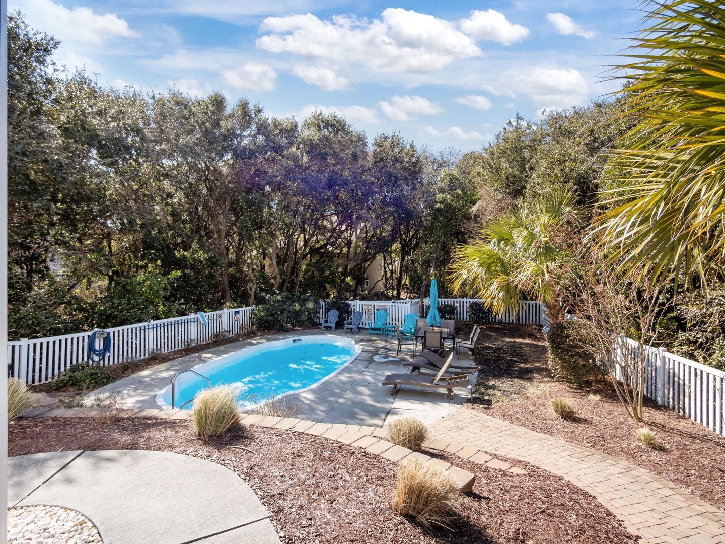 Your private pool oasis awaits, surrounded by tropical palms and perfect for afternoon swims under sunny skies.