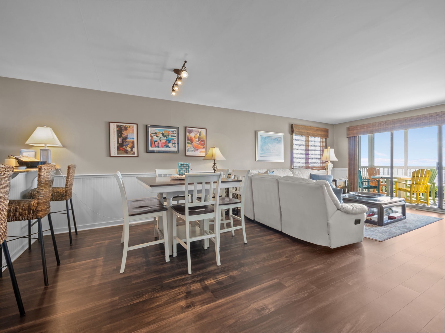 Your bright, open living space flows seamlessly from dining to relaxation, with ocean views through the balcony doors.
