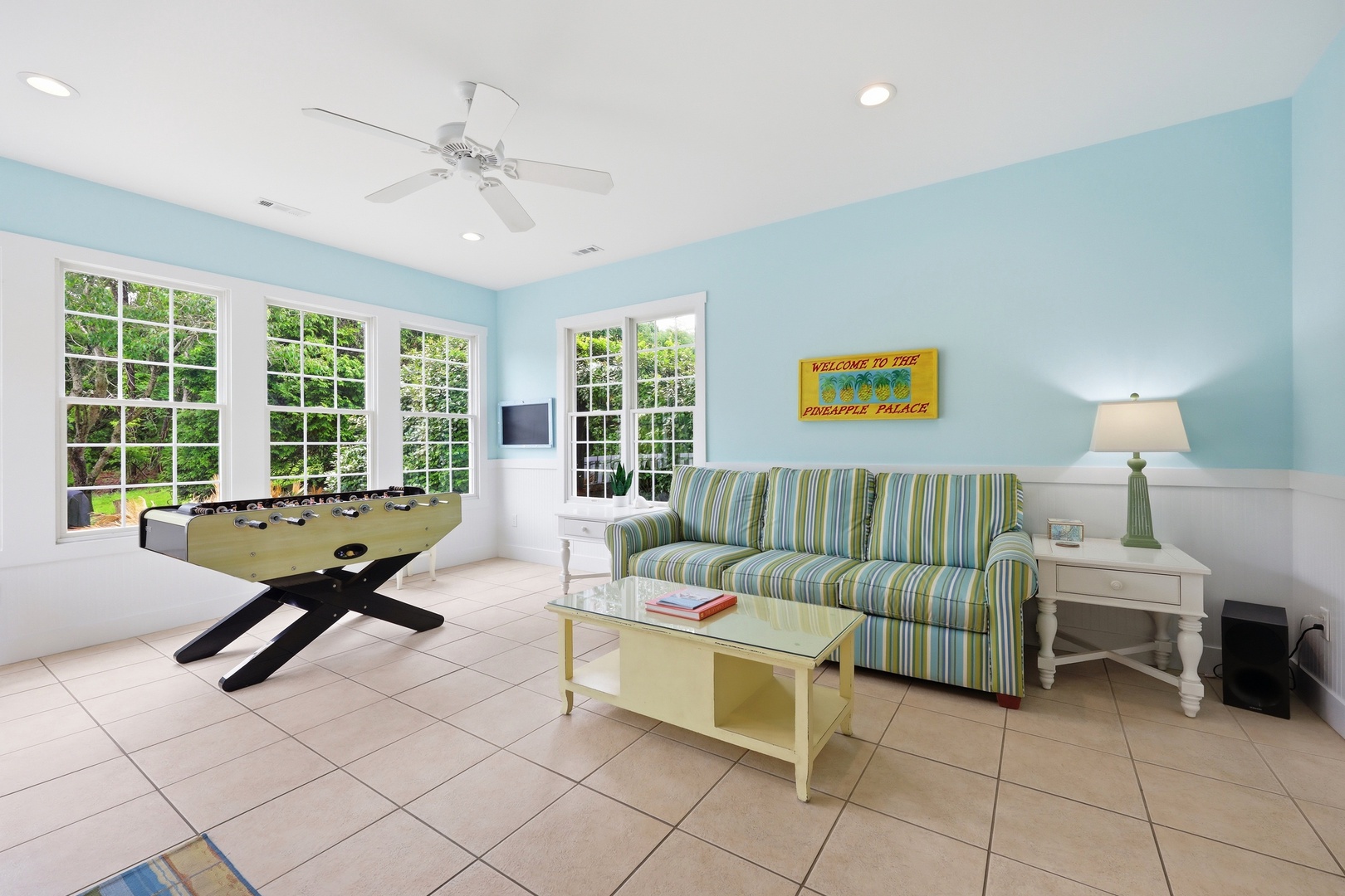 Kick back in your private game room with foosball, comfy seating, and breezy tropical vibes—your perfect spot to unwind between adventures.