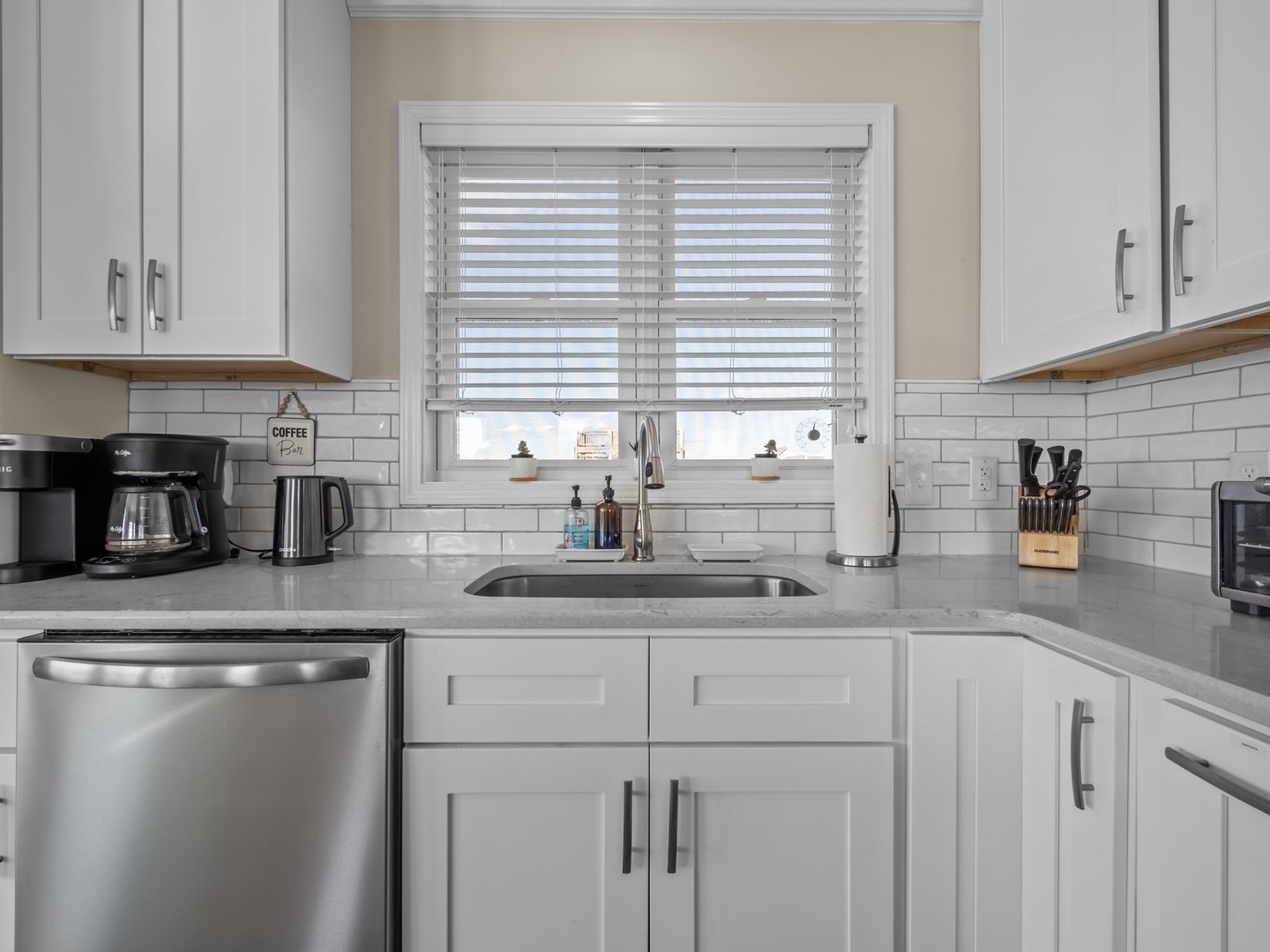 Step into your fully-equipped kitchen with sleek quartz counters, stainless appliances, and coffee maker ready for your perfect morning brew.