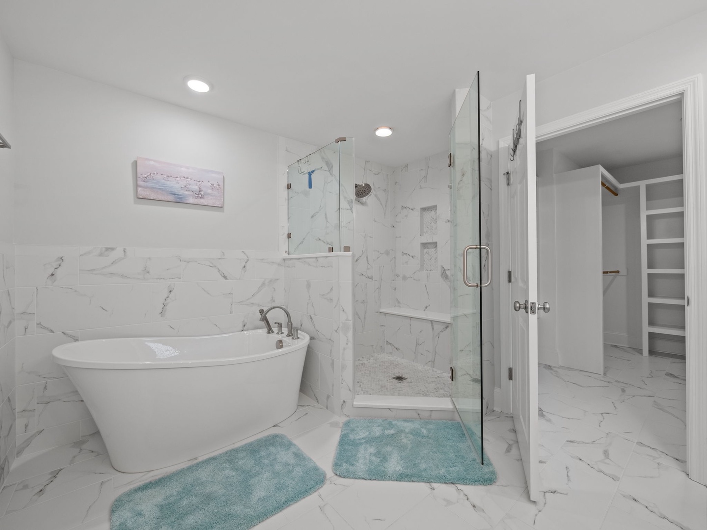 Step into your spa-like ensuite with elegant marble, a soaking tub for relaxing evenings, and a spacious glass shower.