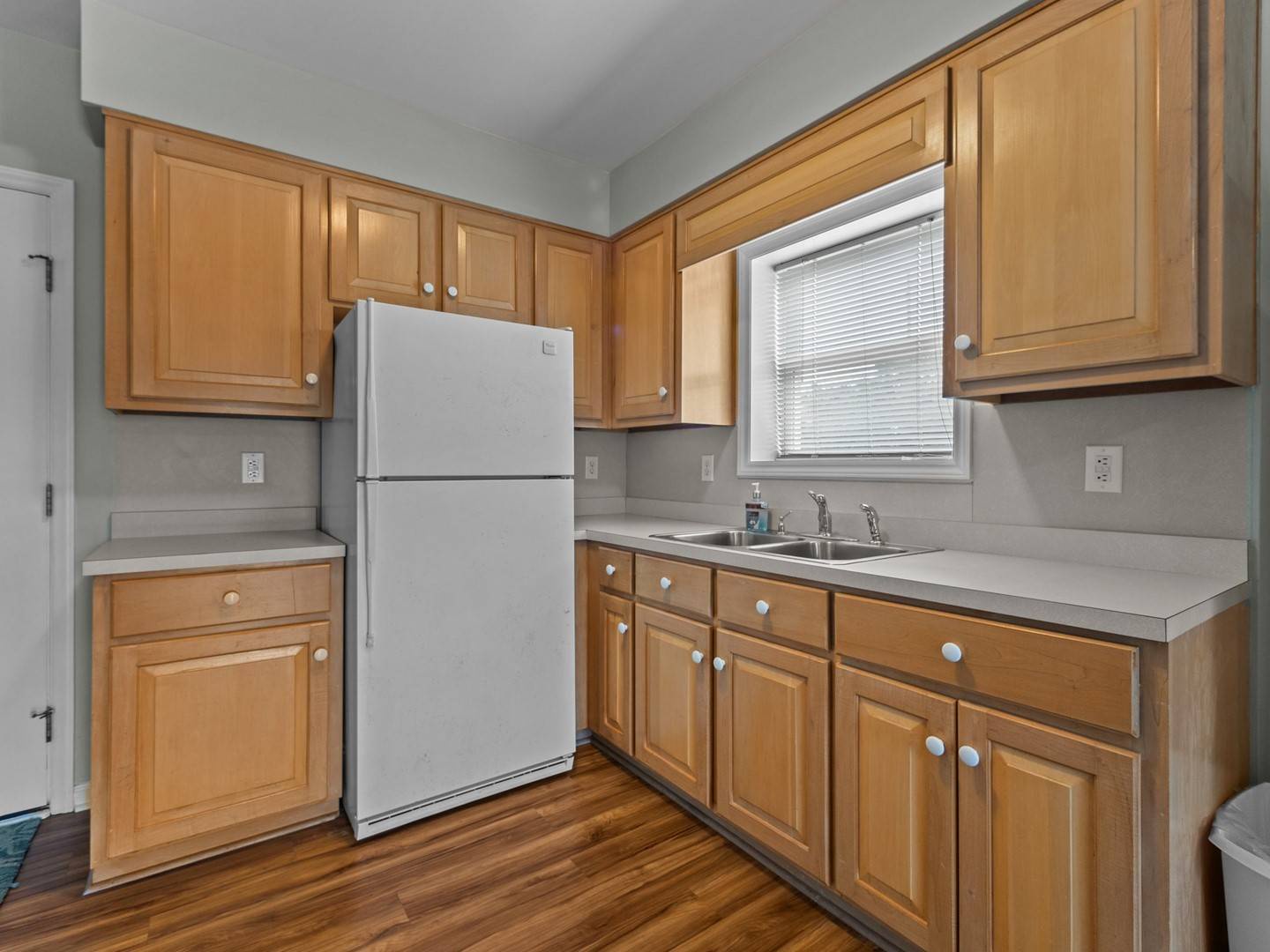 Your well-appointed kitchen features warm wood cabinets, stainless appliances, and ample counter space for preparing meals.