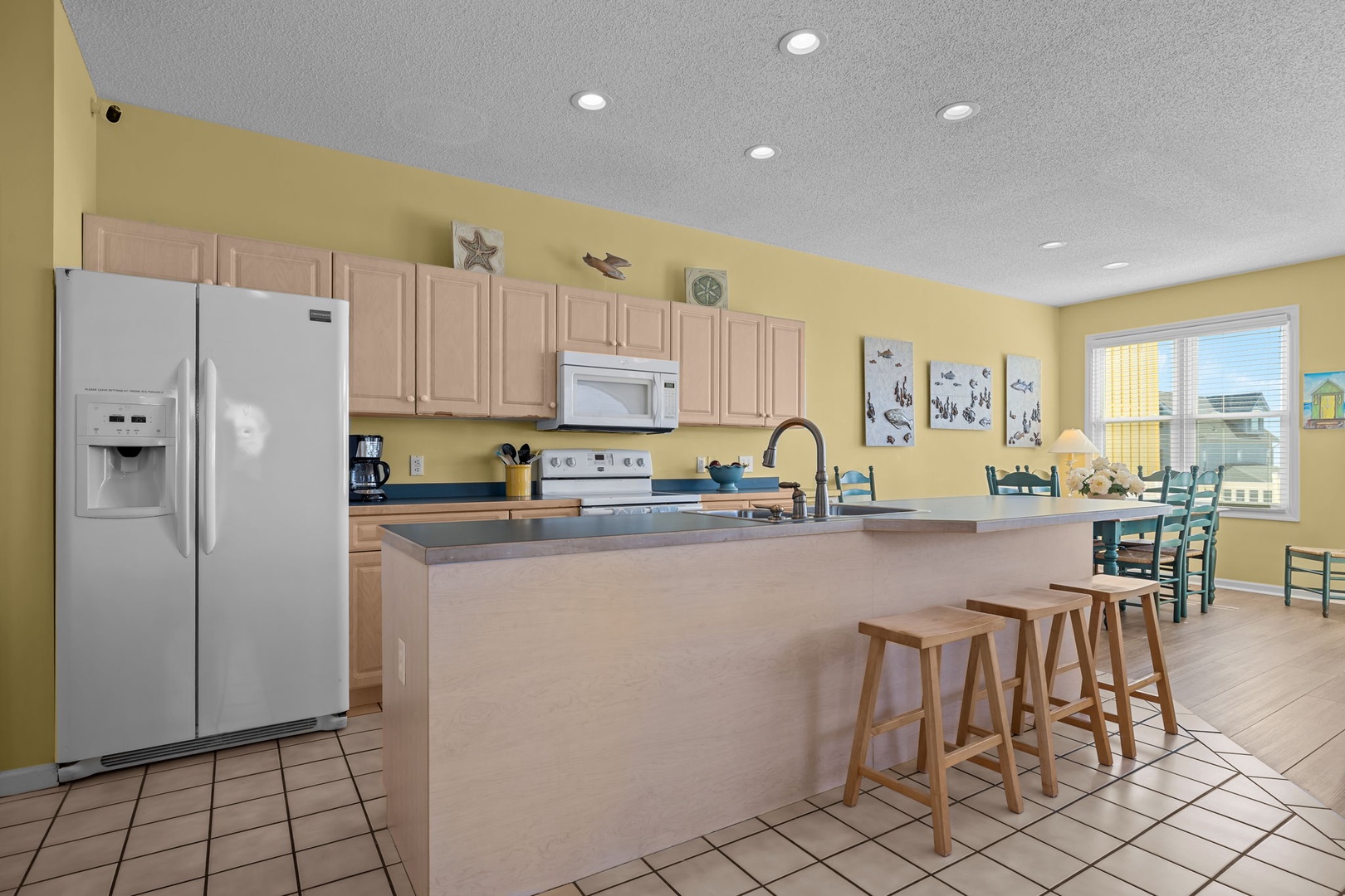 Your spacious kitchen features modern appliances and a breakfast bar where you can enjoy morning coffee while planning your day.