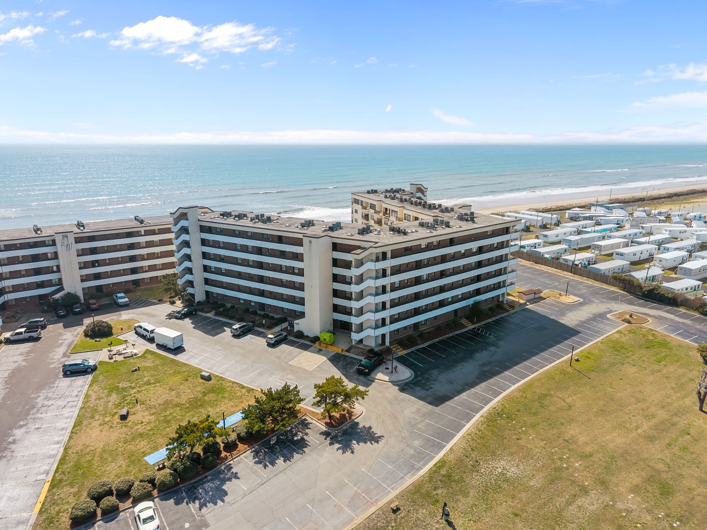 Oceanfront property offers direct beach access with expansive sea views and convenient parking facilities.