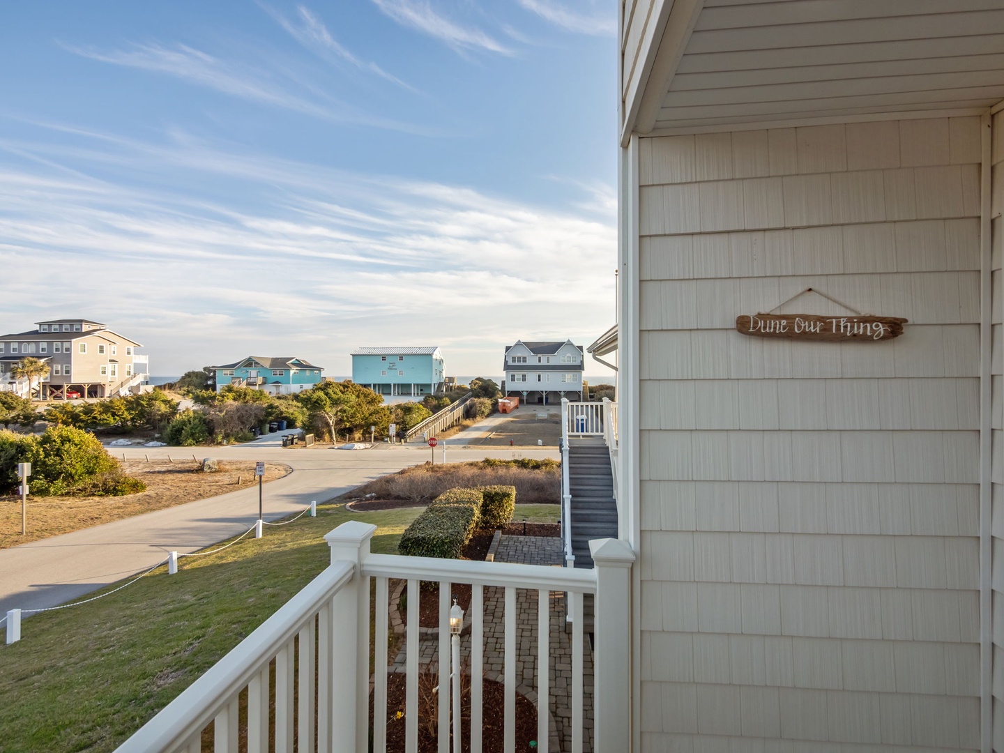 Colorful beach houses dot the coastal landscape with charming neighborhood views from this peaceful retreat.