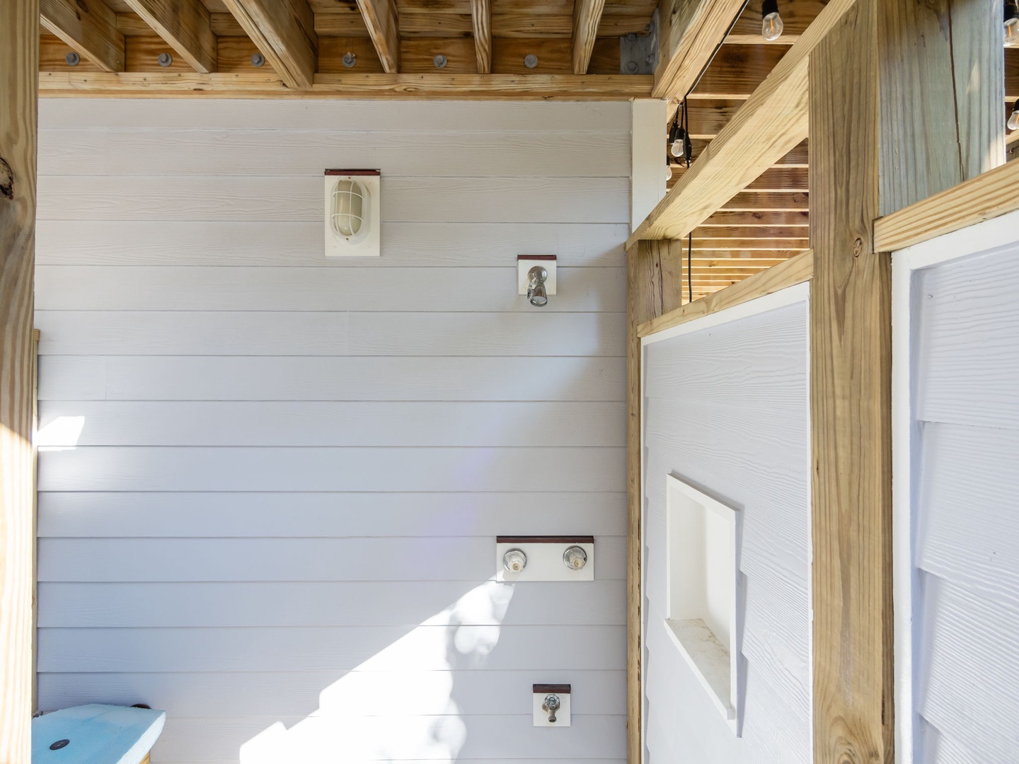 Your private bathroom blends rustic charm with modern comfort, featuring exposed wood beams and crisp white shiplap walls.