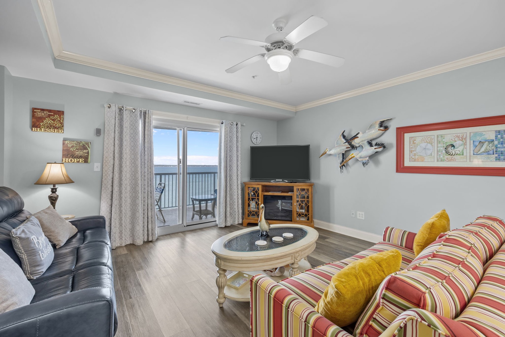 Your coastal living room awaits with plush seating, ocean views, and charming nautical touches that create the perfect beach vacation retreat.