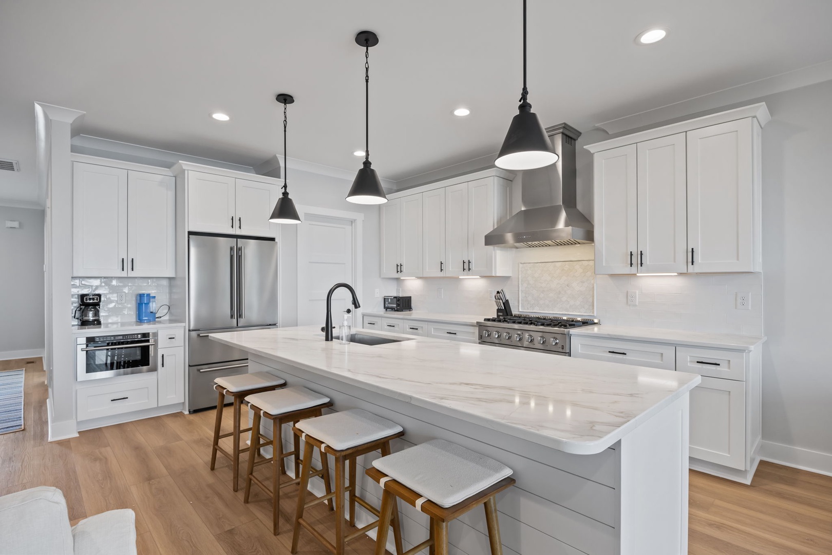 Step into your dream kitchen with pristine white cabinetry, gleaming marble countertops, and modern stainless steel appliances ready for your culinary adventures.