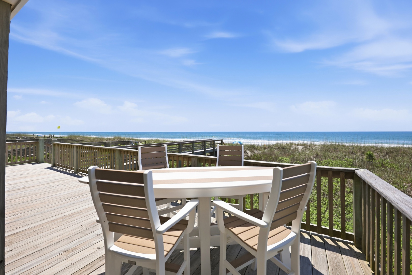 Spacious beachfront deck overlooking pristine white sand and turquoise waters, perfect for morning coffee or sunset dinners with stunning Gulf views.