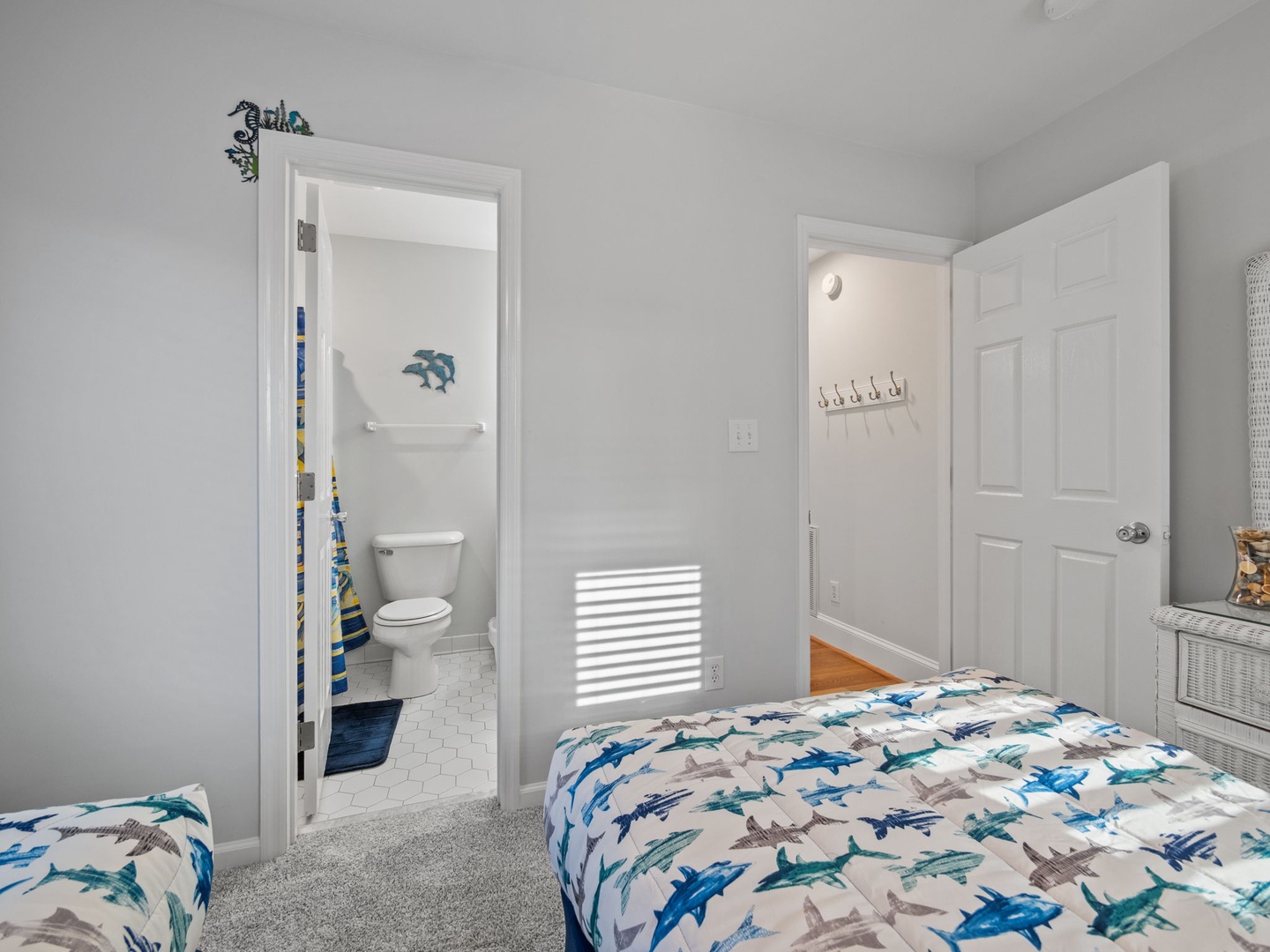 Your shark-themed bedroom offers twin beds and private bathroom access for ultimate comfort and convenience during your stay.