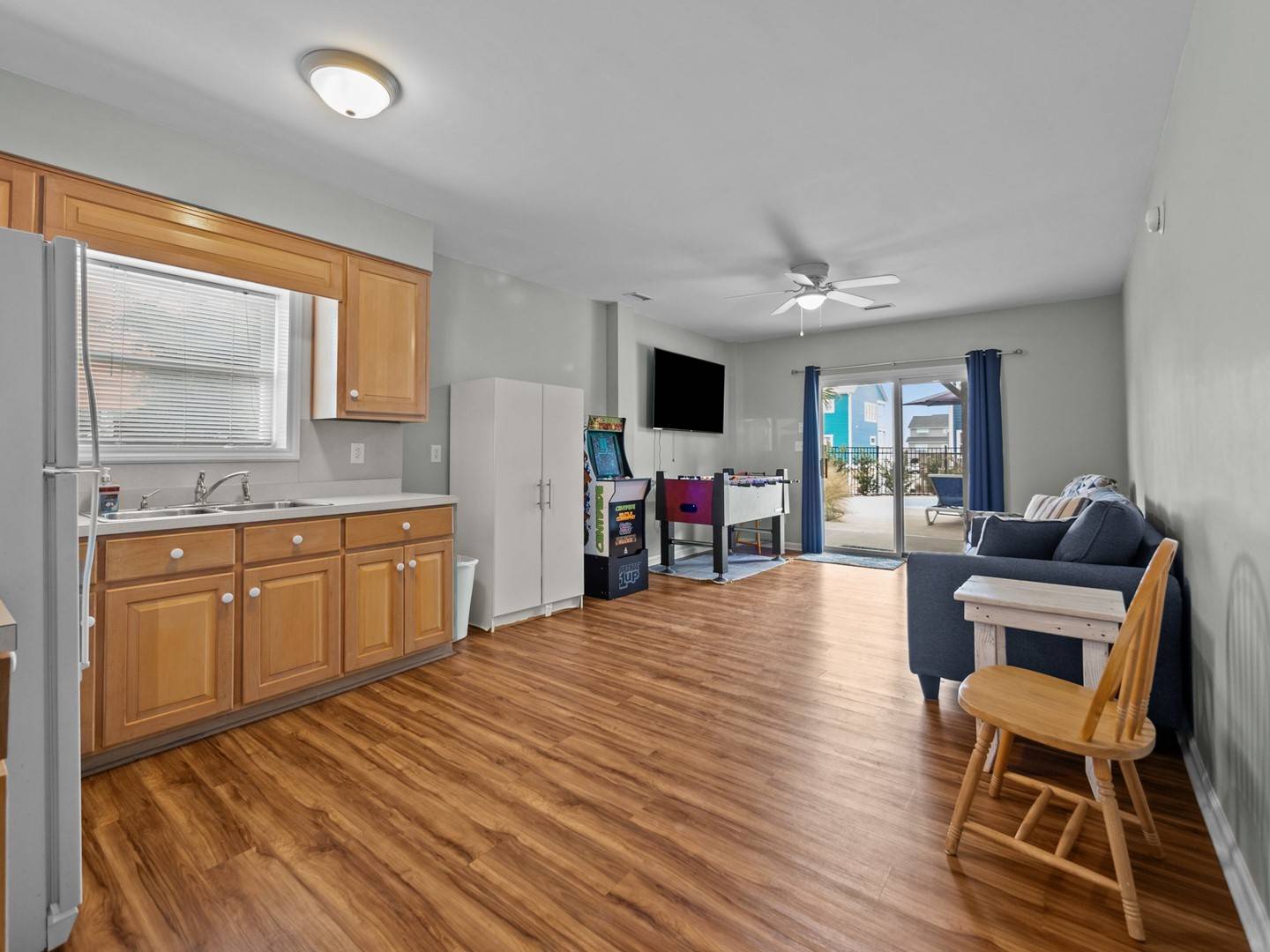 Your spacious open-plan living area features warm hardwood floors, a fully equipped kitchen, and comfortable seating that flows seamlessly to your private balcony.