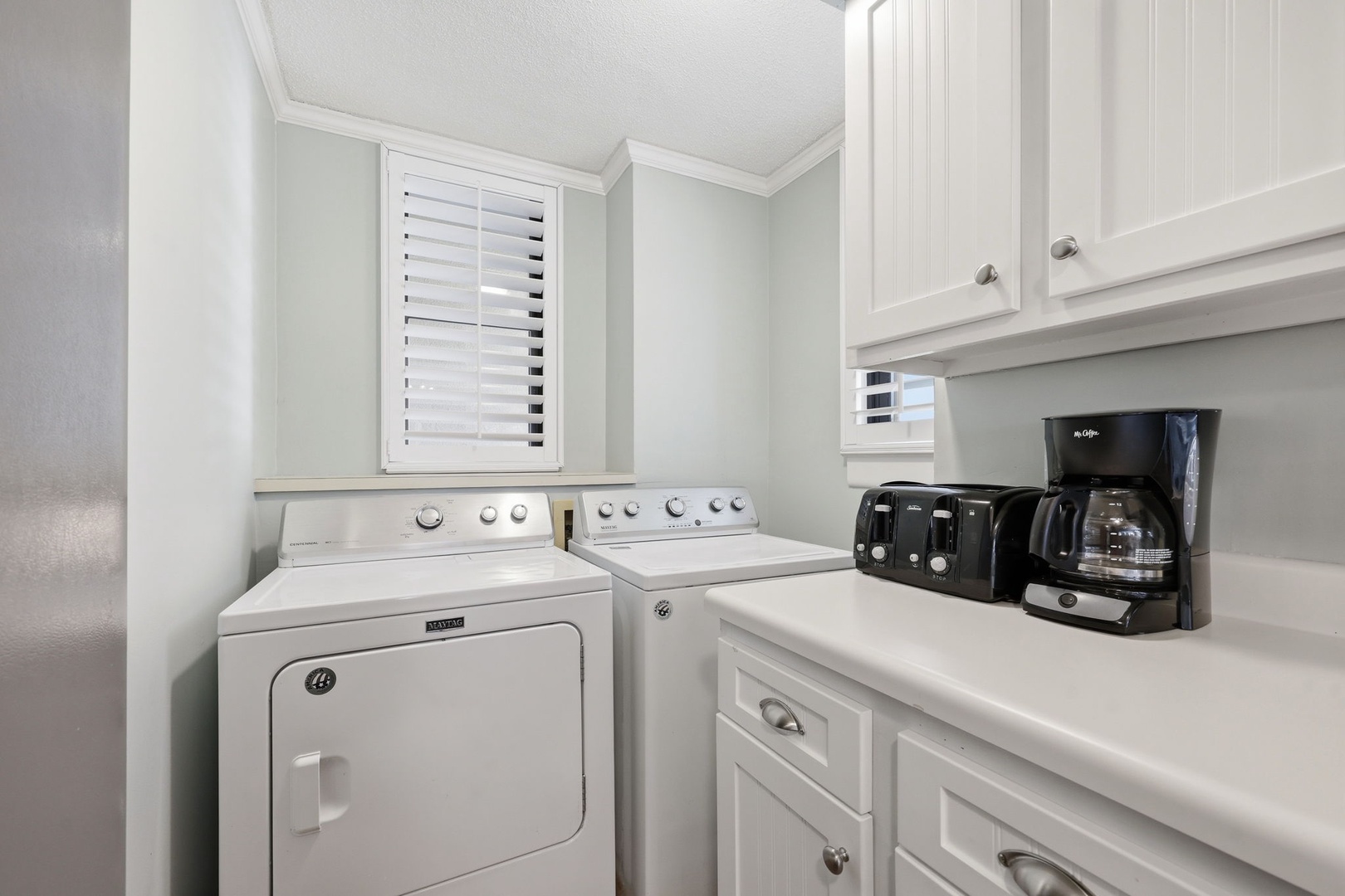 Start your mornings with freshly brewed coffee in this convenient laundry space, complete with a washer and dryer to keep your vacation wardrobe fresh and ready.