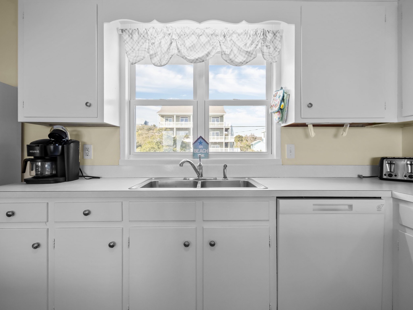 Your bright kitchen features modern appliances and a charming window view, perfect for morning coffee prep.