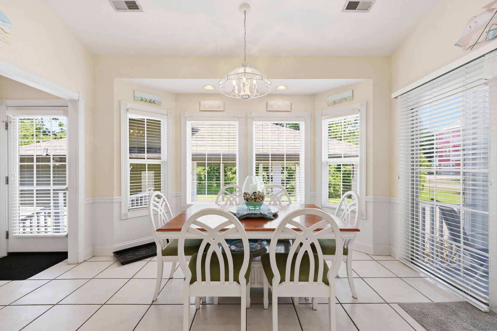 Gather around this bright dining area where natural light pours through bay windows, creating the perfect spot for your morning coffee or family meals together.