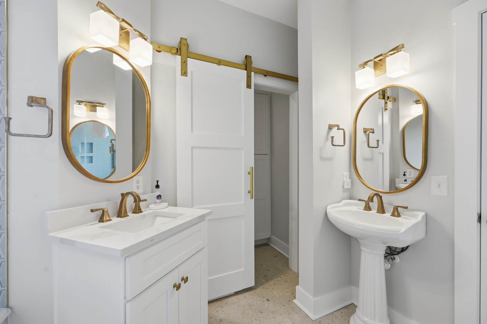 Step into your beautifully appointed bathroom, where elegant gold-framed mirrors, marble countertops, and warm lighting create a refined, spa-like retreat for your morning and evening routines.